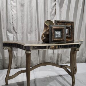 Entryway table with decor and framed mirrors