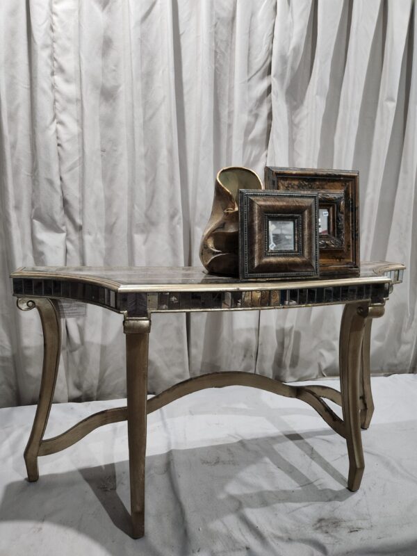 Entryway table with decor and framed mirrors